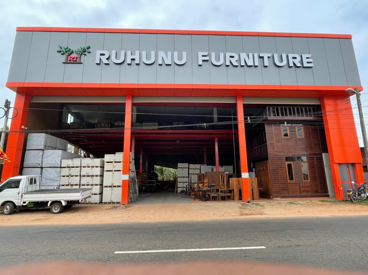 Professional Sri Lankan businessman in navy suit smiling confidently in modern office